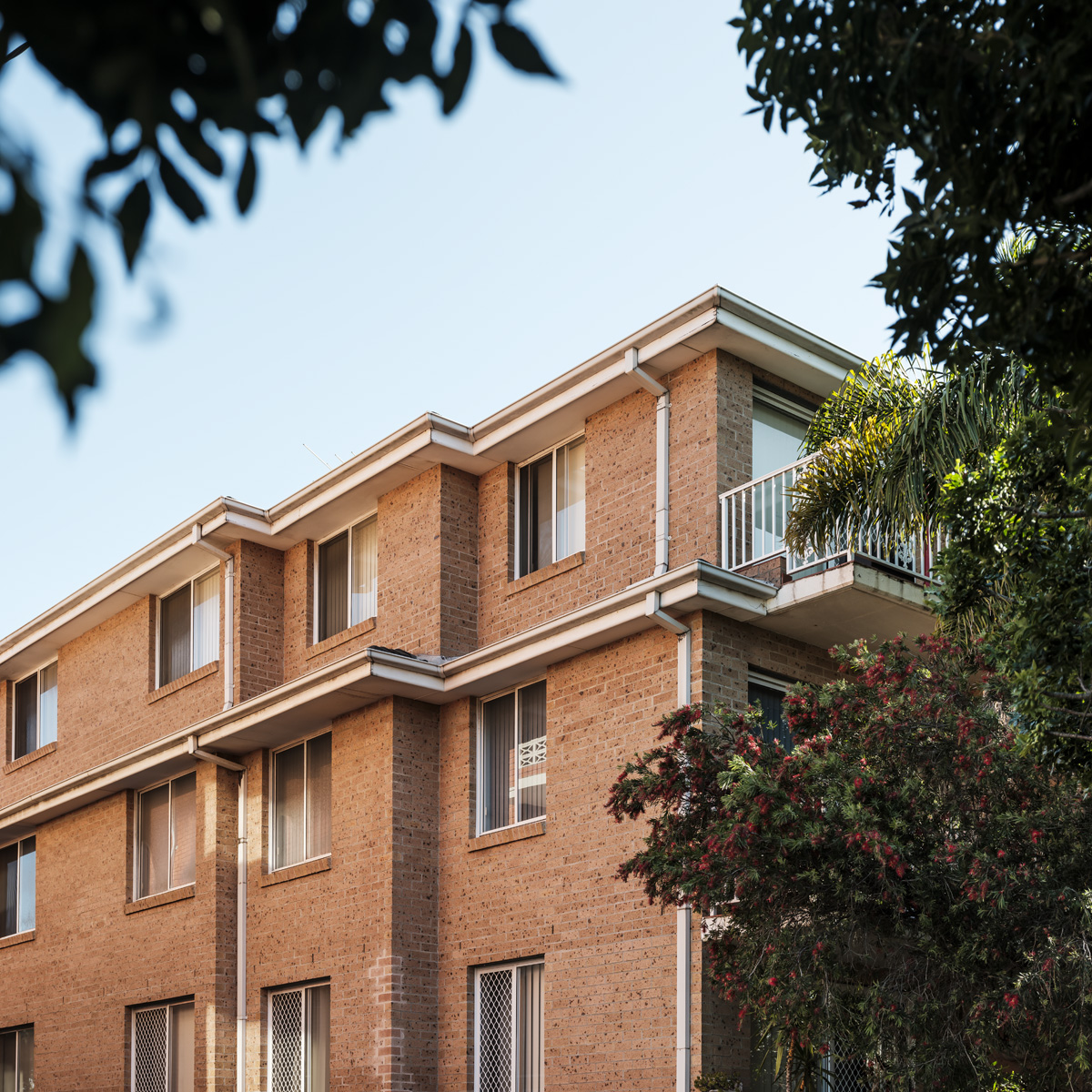 Three-storey brick apartment building with repeated balconies at 321 Maroubra Road
